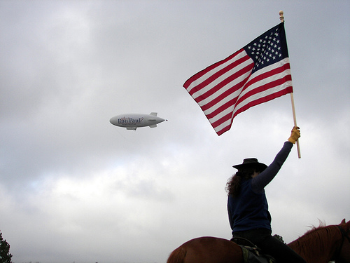 Photo of Ron Paul Blimp and flag-waving supporter by Madwurm